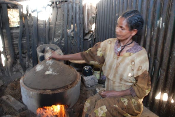 Woman cooking on a fuel-saving stove