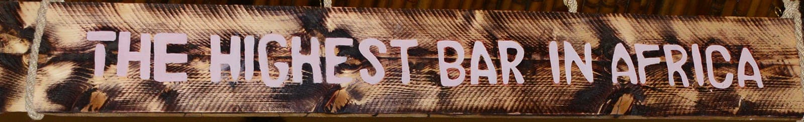 Carved sign reading “The Highest Bar in Africa”