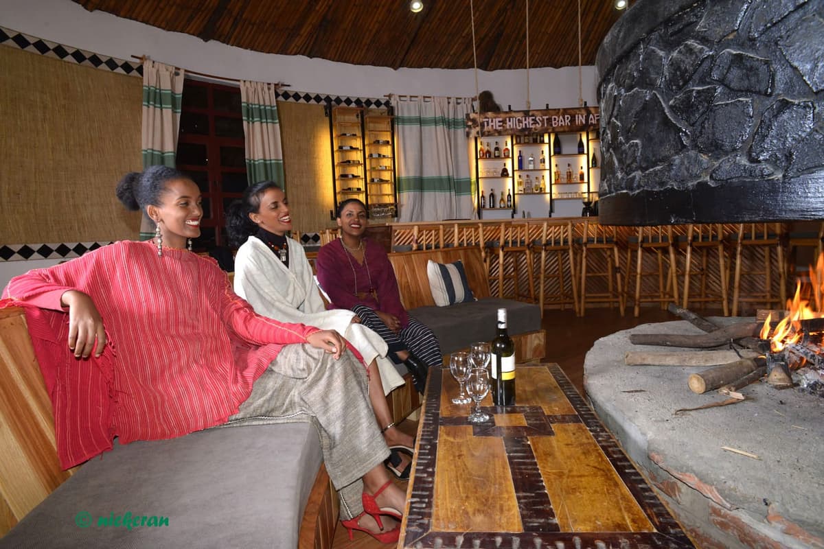 Guests relaxing by the fire in the lounge
