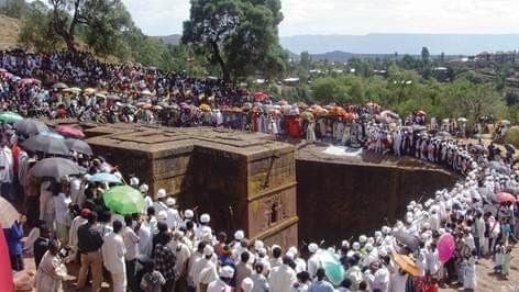 Crowds of pilgrims around a rock-hewn church in Lalibela