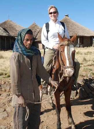 Visitor on horseback led by a local guide