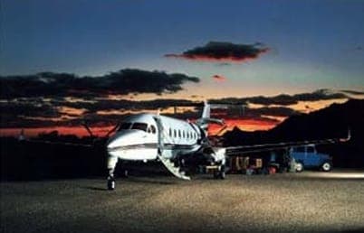 Light aircraft on an airstrip at sunset